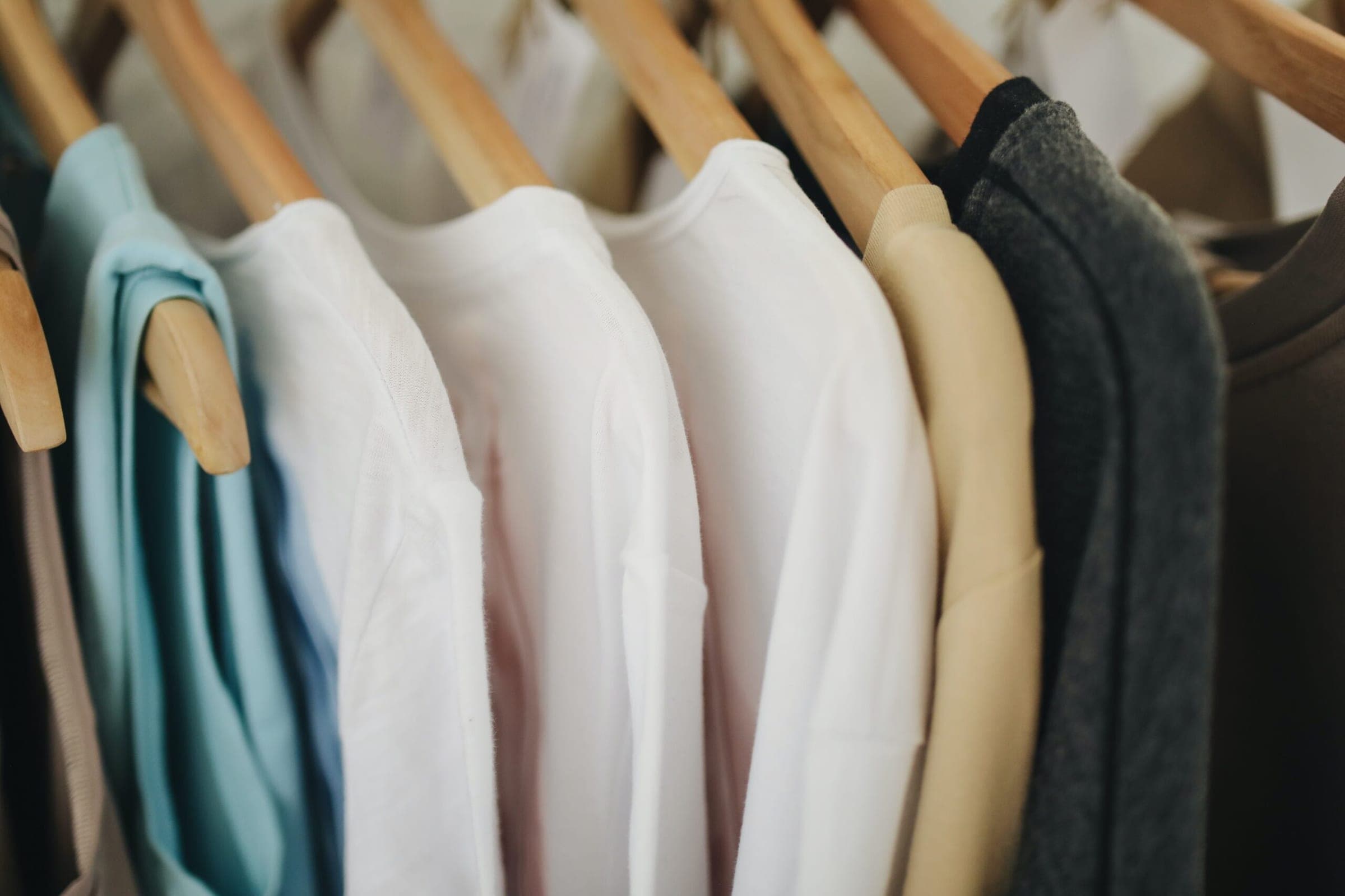 white long sleeve shirts on brown wooden clothes hanger